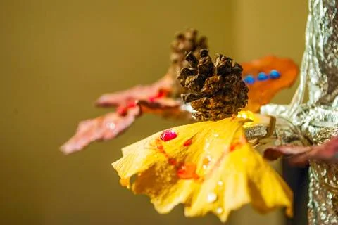 Dry pine cone and multi color leaves christmas tree natural decoration closeup. Stock Photos