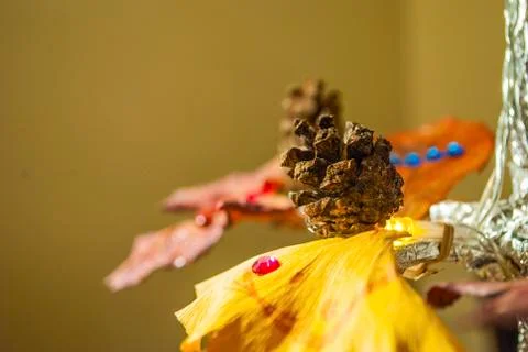 Dry pine cone and multi color leaves christmas tree natural decoration closeup. Stock Photos