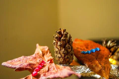 Dry pine cone and multi color leaves christmas tree natural decoration closeup. Stock Photos