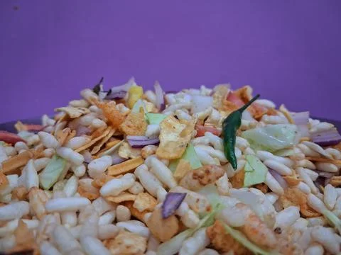 Dry puffed rice grams mixture Mixed Vegetable Jhal Muri on Purple Background Stock Photos