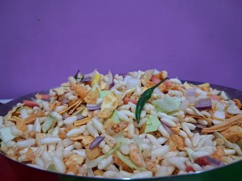 Dry puffed rice grams mixture Mixed Vegetable Jhal Muri on Purple Background Stock Photos