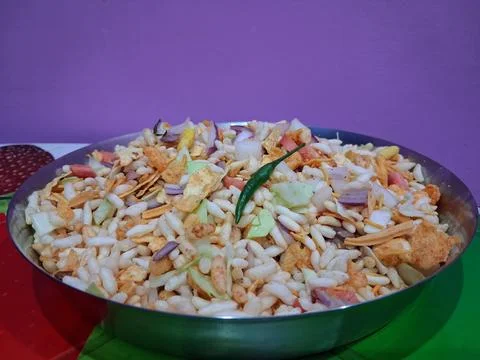 Dry puffed rice grams mixture Mixed Vegetable Jhal Muri on Purple Background Stock Photos