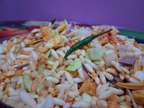 Dry puffed rice grams mixture Mixed Vegetable Jhal Muri on Purple Background Stock Photos