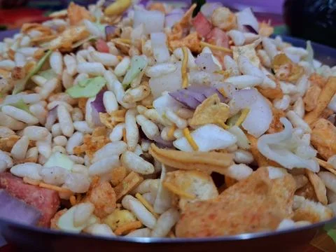 Dry puffed rice grams mixture Mixed Vegetable Jhal Muri on Purple Background Stock Photos