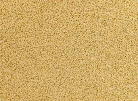 Dry raw couscous grains texture background Stock Photos
