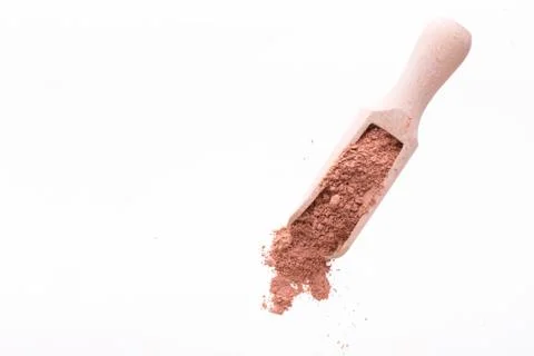 Dry red clay mask for face and body in a wooden spoon. Isolated on a white Stock Photos