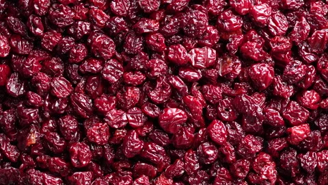 Dry red pitted cherries in the background, closeup, top view, rotate Stock Footage 246721000