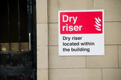 Dry riser located within the building sign Stock Photos