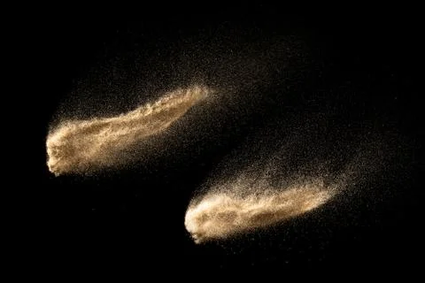 Dry river sand explosion isolated on black background. Abstract sand cloud. Stock Photos