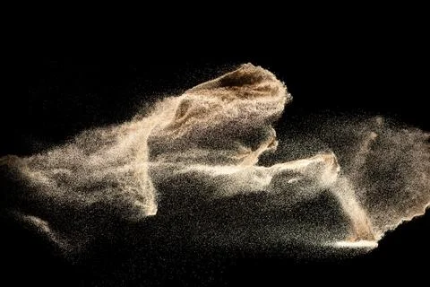 Dry river sand explosion isolated on black background. Abstract sand cloud... Stock Photos