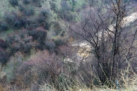 Dry Riverbed and Eroded Hillside Stock Photos