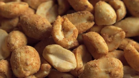 Dry roasted peanuts extreme close up rotating very slowly stock footage Stock Footage 132817424