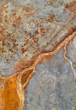 Dry rusty river bed over grey mine tailings, acid mine drainage texture Stock Photos