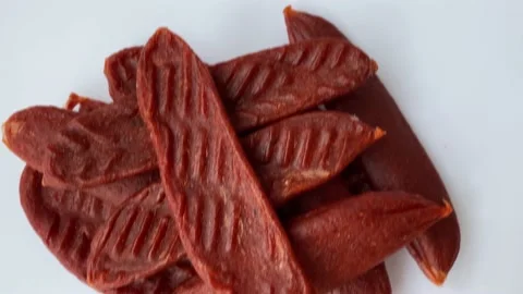 Dry salmon or cod roe caviar sticks on white background. Dried fish snacks for Stock Footage 232030056