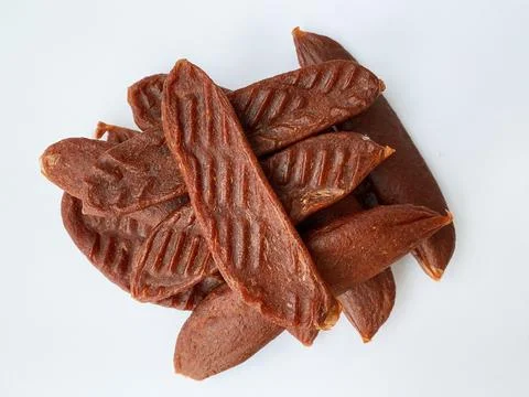 Dry salmon or cod roe caviar sticks on white background. Dried fish snacks for Stock Photos