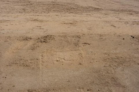Dry sandy ground with subtle textures and natural patterns Stock Photos