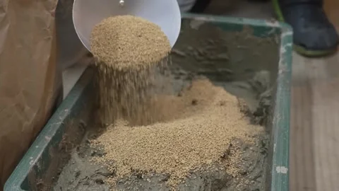 Dry Sandy Soil Pouring from a Scoop into a Mixing Tray Stock Footage 340901002