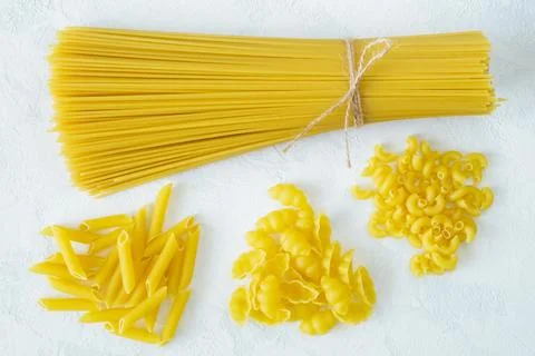Dry several types of pasta on a light background Stock Photos