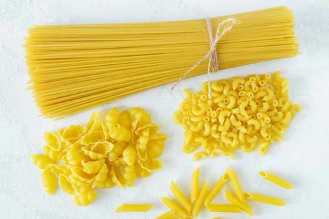 Dry several types of pasta on a light background Stock Photos
