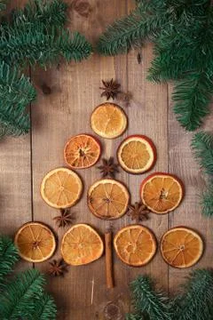 Dry slices of oranges lying on the table. Decorative ornament. C Stock Photos