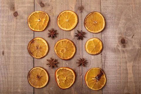Dry slices of oranges lying on the table. Decorative ornament. C Stock Photos
