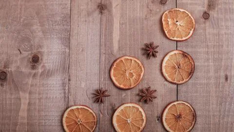 Dry slices of oranges lying on the table. Decorative ornament. C Stock Photos