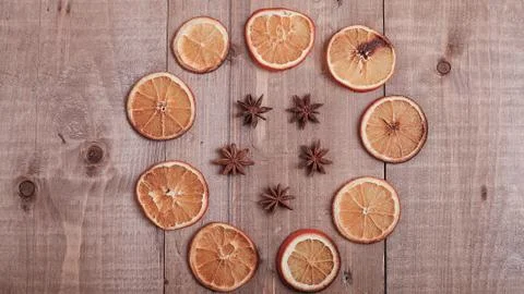 Dry slices of oranges lying on the table. Decorative ornament. C Stock Photos