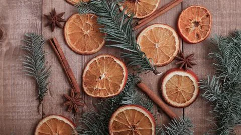 Dry slices of oranges lying on the table. Decorative ornament. C Stock Photos