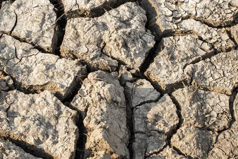 Dry soil with large cracks.A view of parched soil due to the lack of water in Stock Photos