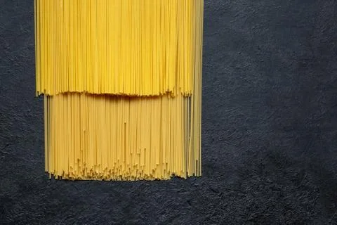 Dry spaghetti close up on a black background with space Stock Photos