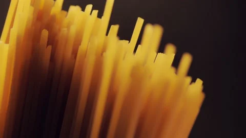 Dry spaghetti close up, macro view of pasta. Yellow food, carb diet, Italian coo Stock Footage 224290326