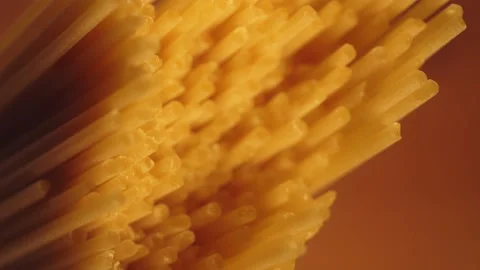 Dry spaghetti close up, macro view of pasta. Yellow food, carb diet, Italian coo Stock Footage 224290380