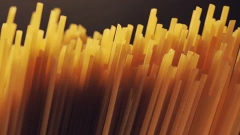 Dry spaghetti close up, macro view of pasta. Yellow food, carb diet, Italian coo Stock Footage 224291190