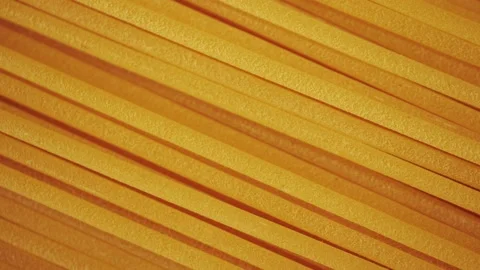 Dry spaghetti close up, macro view of pasta. Yellow food, carb diet, Italian coo Stock Footage 224291193