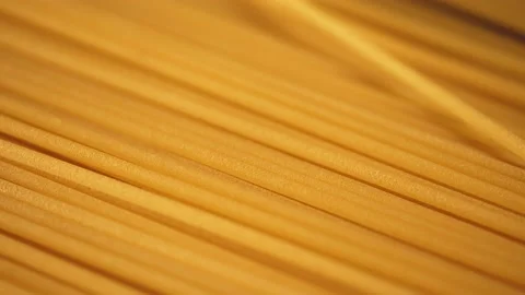 Dry spaghetti close up, macro view of pasta. Yellow food, carb diet, Italian coo Stock Footage 224291467