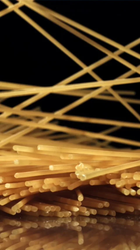 Dry spaghetti falling on a black background. Filmed on a high-speed camera at Stock Footage 335359935