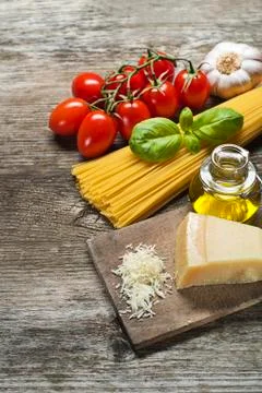 Dry spaghetti with ingredients for pasta meal. Stock Photos