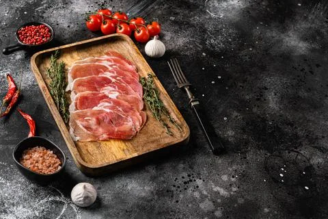 Dry Spanish ham, Jamon Serrano, on black dark stone table background, with co Foto stock