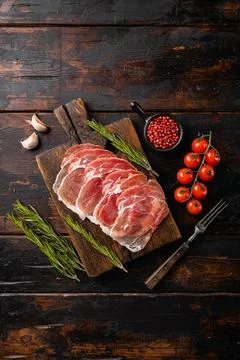 Dry Spanish ham, Jamon Serrano, on old dark wooden table background, top view Stock Photos