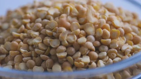 Dry split peas close-up. Macro video of the falling peas. 4K video. Organic Stock Footage 143189516
