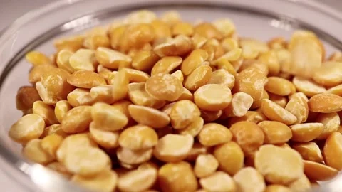 Dry split peas close-up. Macro video of the falling peas. Stock Footage 150863432