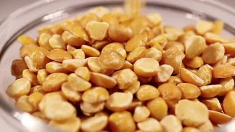 Dry split peas close-up. Macro video of the falling peas. Stock Footage 150863434