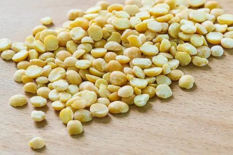 Dry split peas scattered on the kitchen wooden Board Stock Photos