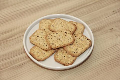 Dry square crackers with black cumin seeds and quinoa for dietary nutrition Stock Photos