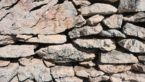 Dry stone wall, close up. Stone wall near the house in countryside at sunset Stock Footage 159688966