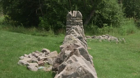Dry stone wall  viewed along top then tilt down to the near end Stock Footage 72568459