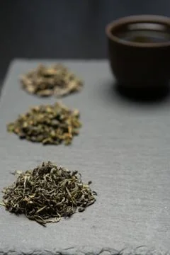Dry tea collection of different types on black background Stock Photos