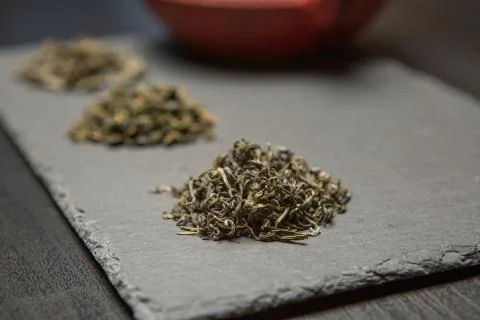 Dry tea collection of different types on black background Stock Photos