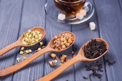 Dry tea in spoons Stock Photos