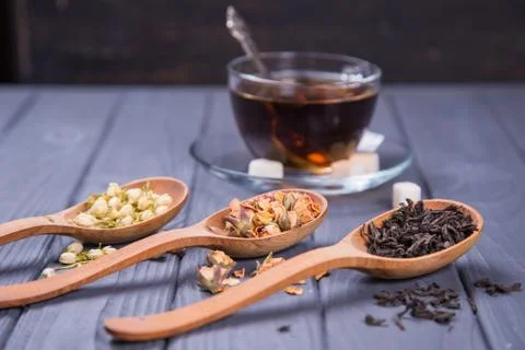 Dry tea in spoons Stock Photos